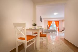 a kitchen and living room with a table and chairs at Mango Apartment Petrovac in Petrovac na Moru
