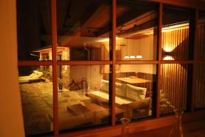 a view of a living room through a window at Der Distelfalter in Oberhaag +32 photos