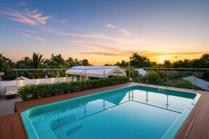 a swimming pool on the roof of a house at Moringa Tree Maison in Siem Reap