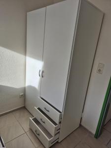 a white refrigerator with its door open in a room at Ferienwohnung Kloster Tempzin 19412 in Tempzin