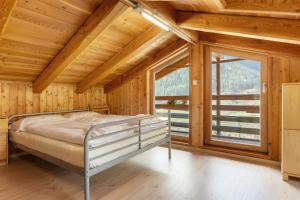 a bedroom with a bed and a large window at Loft Panorama By Immobilux in Rabbi