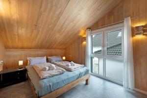 a bedroom with a bed with a wooden ceiling at Ferienhaus Seewald in Seewald