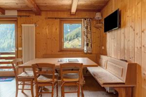 a dining room with a wooden table and chairs at Loft Panorama By Immobilux in Rabbi