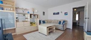 a living room with a couch and a table at Santariškės Apartment in Vilnius