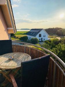 a table and chairs on a balcony with a view at Dia Mare in Ueckeritz