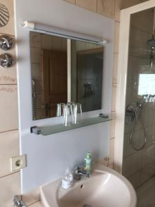 a bathroom with a sink and a mirror at Solhof-Schömberg in Loßburg +126 photos