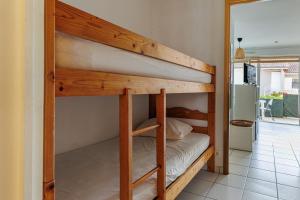 a bunk bed in a room with a bunk bed in a house at Aux Gourbets - Conciergerieland in Vieux-Boucau-les-Bains