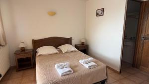 a bedroom with a bed with two towels on it at Ferme de Sejour Rebuffel in La Roque-Esclapon +29 photos