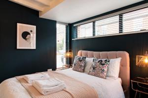 a bedroom with a large bed with blue walls at The Old Bakery in Norwich
