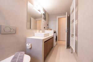 a white bathroom with a sink and a toilet at Aelion Airport Residence By SEM in Artemida +38 photos