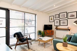 a living room with a couch and a chair at The Old Bakery in Norwich