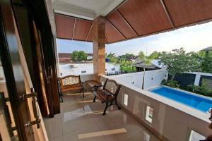 a balcony with a view of a swimming pool at Mega Jaya Villa in Yogyakarta