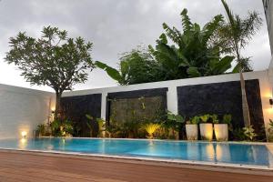 a swimming pool in a yard with plants at Mega Jaya Villa in Yogyakarta