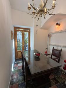 a dining room with a table and chairs and a chandelier at Anema e Core Salerno rooms in Salerno
