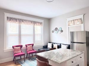 a kitchen with a table and chairs and a refrigerator at Carytown nest King Bed fully fenced in Richmond +15 photos