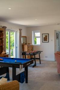a living room with a pool table in it at Chuggs Orchard in Croyde