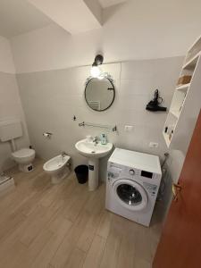 a bathroom with a washing machine and a sink at Appartamenti La Quiete in Mele +57 photos