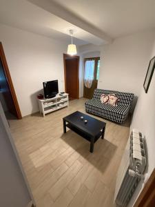 a living room with a couch and a coffee table at Appartamenti La Quiete in Mele