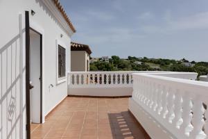 a balcony of a house with a white railing at Casa Familiar La Lobita 2 in Conil de la Frontera