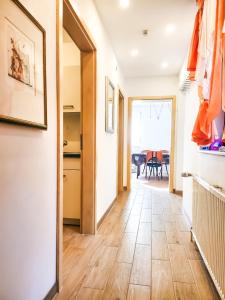 a hallway with a door to a kitchen and a dining room at My FeWo in Germersheim