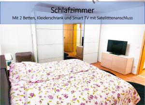 a poster of a bedroom with a bed and a tv at My FeWo in Germersheim