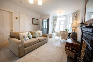 a living room with a couch and a fireplace at Ty Haf in Rhosneigr