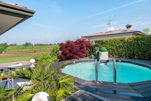 a swimming pool in the backyard of a house at Villa Benaco in Pozzolengo