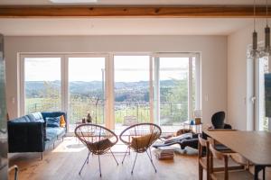 a living room with a couch and a table and chairs at HeartArt 2 in Bad Münstereifel