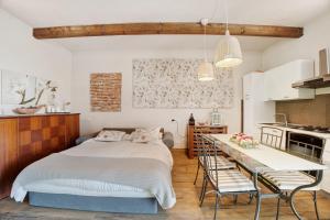 a bedroom with a bed and a table and chairs at Cascina Brignolo - Casa Bianca in Novara