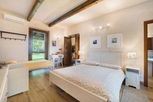 a bedroom with two beds and a table at Cascina Brignolo - Casa Bianca in Novara