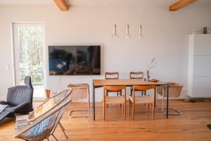a dining room with a table and chairs at HeartArt 2 in Bad Münstereifel