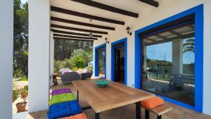 a patio with a wooden table and chairs at Villa Radi by Eivillas in Santa Gertrudis de Fruitera