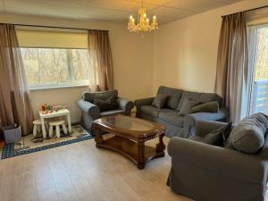 a living room with two couches and a coffee table at Konrad Guesthouse in Kuressaare