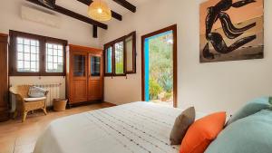 a bedroom with a large bed in a room at Villa Radi by Eivillas in Santa Gertrudis de Fruitera +51 photos