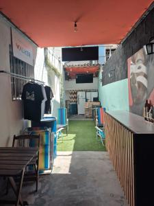 a patio with chairs and a table and a wall at Nomad Hostel - Vila Madalena in São Paulo