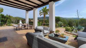 a patio with chairs and a table with a view at Villa Radi by Eivillas in Santa Gertrudis de Fruitera