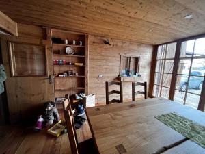 a room with a table in a wooden house at Ferienhof Forstmoar in Gars am Inn