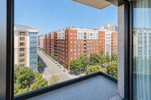 an apartment balcony with a view of buildings at Apartamentos 2H LIVING in León