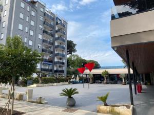 a building with a red heart sculpture in a parking lot at Indy Sea Home in Lido degli Estensi