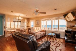 a living room with a couch and a table at Lady Dune in Oak Island +65 photos
