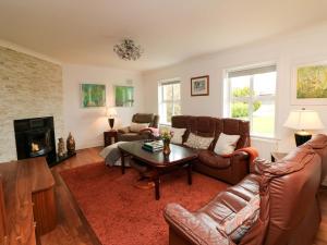 a living room with a couch and a table at Sunnyside in Riverchapel