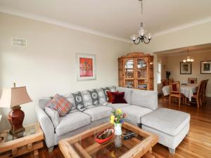 a living room with a couch and a table at Sunnyside in Riverchapel