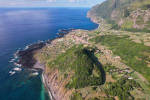 an aerial view of a mountain next to the ocean at Ocidente House 2 in Santa Cruz das Flores