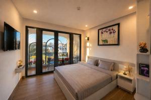 a bedroom with a bed and a large window at Happy Life Hotel DaLat in Da Lat