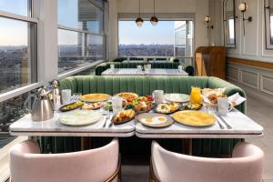 a table with plates of food on it in a restaurant at CVK Taksim Hotel Istanbul in Istanbul