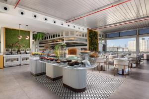 a large kitchen with a table with food on it at CVK Taksim Hotel Istanbul in Istanbul +92 photos