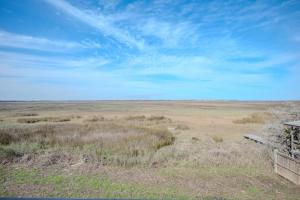 a view of a large open field with a blue sky at Late For The Sky in Caswell Beach