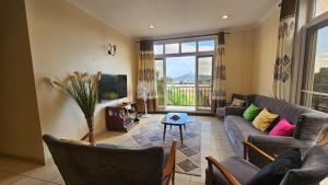 a living room with a couch and a tv at JJ Comfort Homes in Arusha