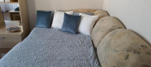 a couch with two pillows on it in a room at Santariškės Apartment in Vilnius