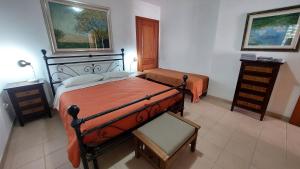 a bedroom with a large bed and a chair at Residence degli ulivi in Ossi +14 photos